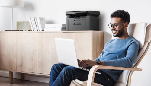 man sitting on laptop